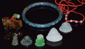 Four jadeite pendants, a tiger's eye Fu dog and a cloisonné bangle