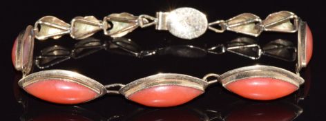 A 14k gold bracelet set with marquise cut coral cabochons, 8g