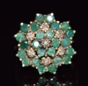 A 9ct gold ring set with round cut emeralds and diamonds in a large cluster, 4.7g, size O
