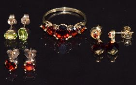 A 9ct gold ring set with garnets, two pairs of 9ct gold earrings set with garnets and a pair of
