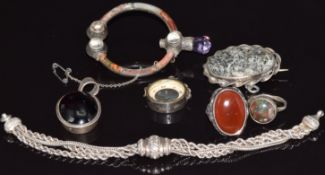 A Scottish agate silver brooch, silver ring, silver pendant set with a garnet cabochon, silver
