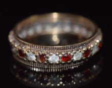 A 9ct gold eternity ring set with alternating paste and garnets, 3.5g, size O