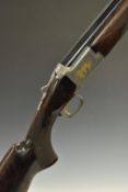 Browning Citori 12 bore over and under shotgun with gold engraving of birds and dogs surrounded by