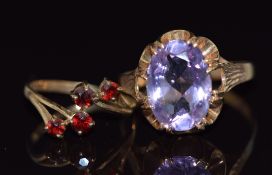 A 9ct gold ring set with an oval cut amethyst and a 9ct gold ring set with garnets, 5.4g, sizes K