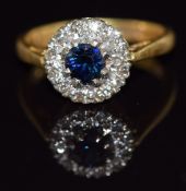 An 18ct gold ring set with a sapphire and diamonds, 3.3g, size I