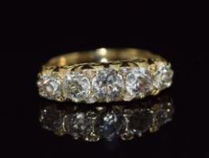 An 18ct gold ring set with five old cut diamonds measuring 0.65, 0.45, 0.45, 0.3ct & 0.3ct