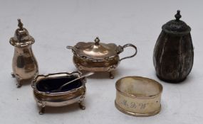 Two hallmarked silver peppers, open salt and mustard, with blue glass liners, together with a