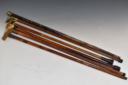 Six walking sticks including a carved horn jockey's cap and hallmarked silver mounted examples