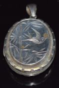 A Victorian silver locket with engraved bamboo and bird decoration verso floral decoration, 4 x 3.