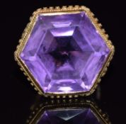 A 9ct gold ring set with a large hexagonal amethyst with a rope and sphere border, 9.9g, size K