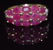 A 9ct gold ring set with 12 oval cut rubies and diamonds, 3g, size P