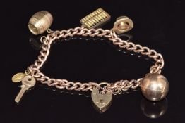 A 9ct gold charm bracelet with five charms including 9ct gold sphere, hat, barrel, abacus, key &