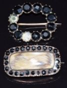 Georgian brooch set with hair and paste engraved verso 'MD Obt 10th August 1808 at 63' and another