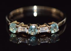 A 9ct gold ring set with round cut green sapphires and baguette cut white sapphires, 18g, size P/Q
