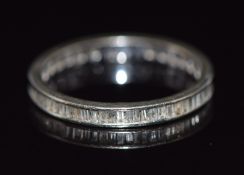 A 10k gold eternity ring set with baguette cut diamonds, 1.4g, size N
