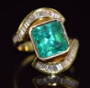 An 18ct gold ring set with a natural Colombian apple green emerald of approximately 5ct and 34