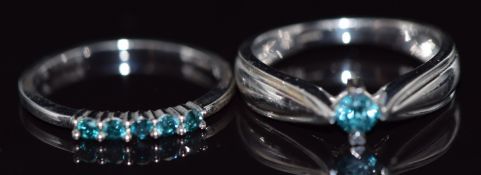 A 14k white gold ring set with five blue diamonds and a 9k gold ring set with a blue diamond