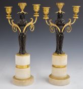 A pair of 18thC bronze and ormolu figural candelabra with detachable swivel sconces, raised on