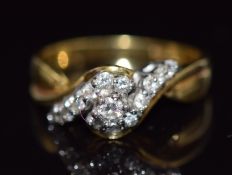 An 18ct gold ring set with round cut diamonds in a twist setting, size N, 5.2g