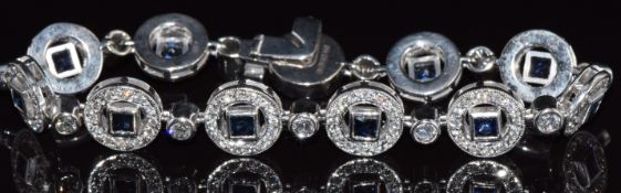 A 14ct white gold bracelet set with princess cut tanzanites and diamonds (total diamond weight