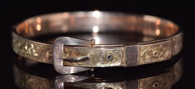 A 9ct rose gold buckle bangle with engraved decoration, 8.6g