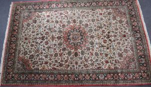 Persian rug with central floral cartouche within a floral border, 320 x 210cm, with a label for