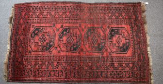 Turkoman rug with four guls on a wine ground, 196 x 116cm