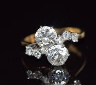 An 18ct gold ring set with two old cut diamonds each approximately 1.1ct with six further diamonds