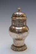 George V Arts and Crafts hallmarked silver sugar caster with pierced cover, embossed lion mask