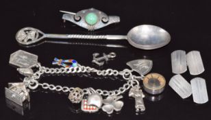 A pair of silver cufflinks, white metal brooch, silver charm bracelet etc