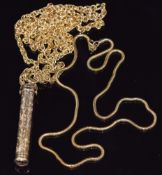 Two yellow metal necklaces and a yellow metal pencil