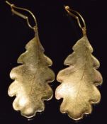 A pair of 14ct gold earrings in the form of an oak leaf with textured decoration, 14g
