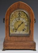 Winterhalder and Hoffmeier mitre cased mantel clock with brass spandreled dial and arch, silvered
