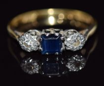 An 18ct gold ring set with a square cut sapphire and diamonds in platinum setting, 2.4g, size K