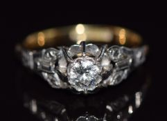 An 18ct gold ring set with a round cut diamond of approximately 0.3ct in a platinum setting, 3.1g,