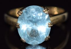 A 9ct gold ring set with an oval cut blue topaz, size N