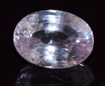 A loose oval cut pink sapphire of approximately 4.3cts, 0.9g