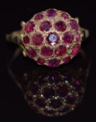 A 9ct gold ring set with a cluster of round cut rubies, 3.1g, size O