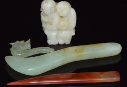 A Chinese jade carving of two boys, an agate paper knife, jade paper knife and a jadeite dragon