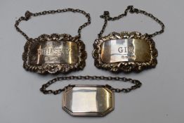Three modern hallmarked silver bottle tickets comprising a pair (one gin the other whisky) the other