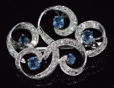A white gold brooch set with oval cut sapphire and diamonds, 3.8 x 2.8cm, 8.6g