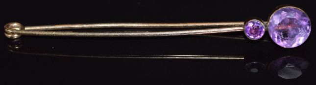 Victorian yellow metal pin set with two round cut amethysts