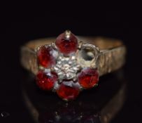 A 9ct gold ring set with a diamond and garnets, 2.7g, size O