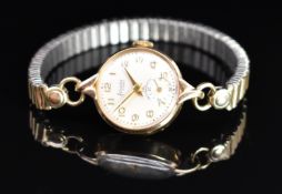 Accurist 9ct gold ladies wristwatch with inset subsidiary seconds dial, gold hands and Arabic