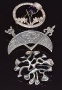 Three silver brooches, one in the form of a thistle by W B S, a Scottish silver example and one