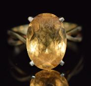 A 14k gold ring set with an oval cut citrine, 4.1g, size M/N