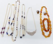 Five pearl necklaces set with rubies, sapphires, garnets and lapis lazuli, and an amber necklace and