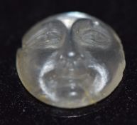 A loose moonstone carved as the man in the moon, 0.92cm