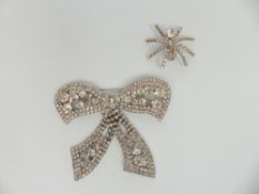 A vintage bow brooch set with diamanté and a vintage brooch in the form of a spider set with paste