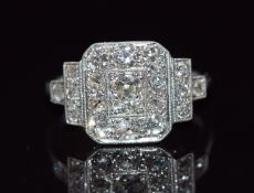Art Deco platinum ring set with old cut diamonds in a rectangular setting, the tiered shoulders